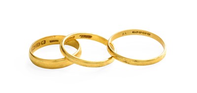 Lot 150 - Three 22 Carat Gold Band Rings, finger sizes P,...