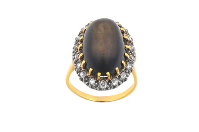 Lot 2117 - A Cat's-Eye Stone and Diamond Cluster Ring the...