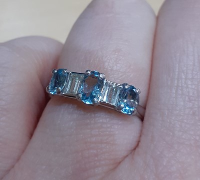 Lot 2029 - An Aquamarine and Diamond Five Stone Ring...