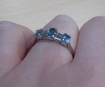 Lot 2029 - An Aquamarine and Diamond Five Stone Ring...