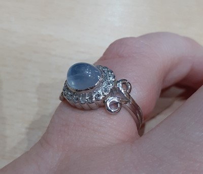 Lot 2026 - A Moonstone and Diamond Cluster Ring the oval...