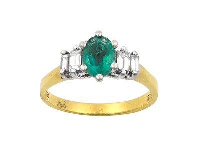 Lot 2101 - An Emerald and Diamond Ring the oval cut...