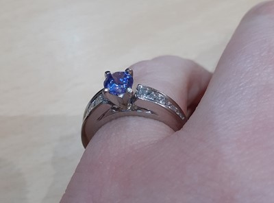 Lot 2007 - A Tanzanite and Diamond Ring the round cut...