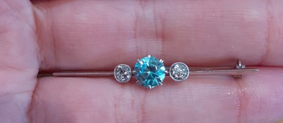 Lot 2058 - A Blue Zircon and Diamond Three Stone Brooch...
