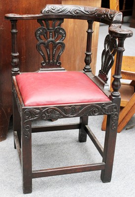 Lot 1169 - A Carved Oak Corner Chair