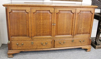 Lot 1146 - An Oak Dresser Base, with panelled doors and...