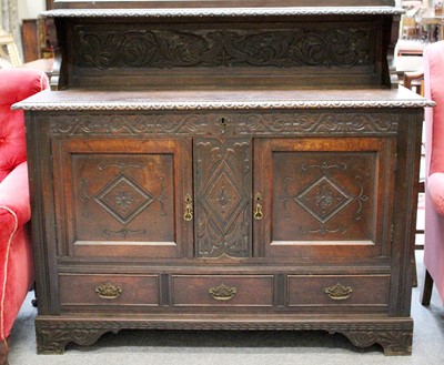 Lot 1409 - A 1920s Carved Oak Sideboard, with egg and...