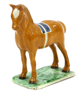 Lot 106 - A Pearlware Model of a Horse, circa 1800-10,...