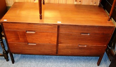 Lot 856 - A 1960's mahogany side cabinet, the rectangular top over two banks of three graduating drawers,...