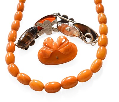 Lot 204 - A Graduated Amber Bead Necklace, length 67cm;...