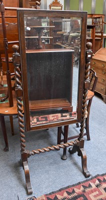 Lot 1239 - A1920s Oak Cheval Mirror, on barley twist...