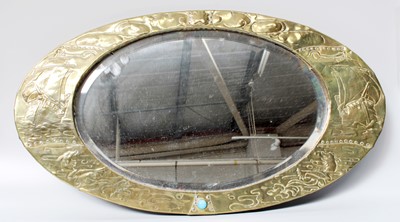 Lot 1333 - An Art and Crafts Brass Mounted Oval Mirror,...