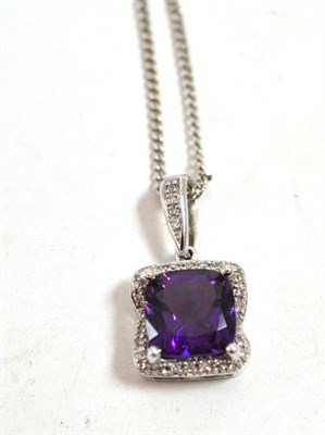 Lot 11 - A 9ct white gold amethyst and diamond pendant on chain