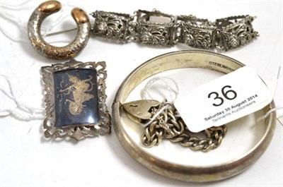 Lot 36 - A silver curb and lock bracelet, a marcasite set floral panel bracelet, a Siamese brooch, a...