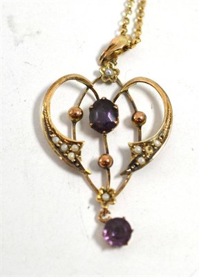 Lot 39 - An early 20th century amethyst and seed pearl pendant stamped '9CT' on chain