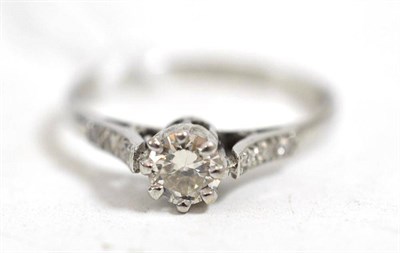 Lot 46 - A diamond solitaire ring, with stone set shoulders, stamped 'PLAT', estimated diamond weight...