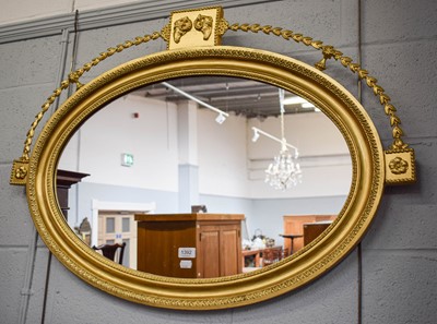 Lot 1392 - A Gilt Framed Oval Mirror, with rams head...