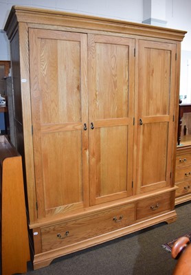 Lot 1477 - A Pair of Modern Oak Triple Wardrobes, fitted...