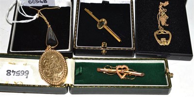 Lot 125 - A bar brooch stamped '15CT', another bar brooch, a locket and two pendants on chains
