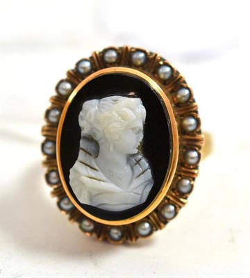 Lot 136 - A hardstone cameo ring within a pearl border