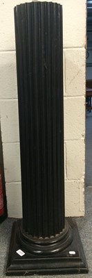 Lot 1374 - An Ebonised Fluted Column, on stepped square...