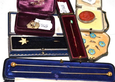 Lot 147 - Two hat pins, a seed pearl set maple leaf motif pin, turquoise pin, a badge, enamelled brooch...