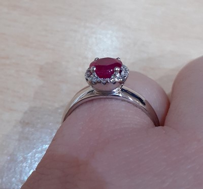 Lot 2066 - A Ruby and Diamond Cluster Ring the round cut...