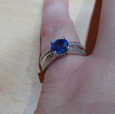Lot 2019 - A Sapphire and Diamond Ring the oval cut...