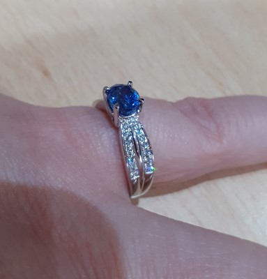 Lot 2019 - A Sapphire and Diamond Ring the oval cut...