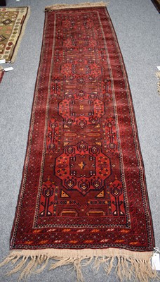 Lot 1268 - A Narrow Afghan Turkmen Runner, the aubergine...