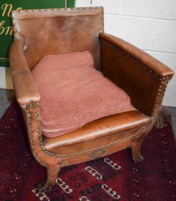 Lot 1330 - An Early 20th Century Tan Leather Tub Armchair,...