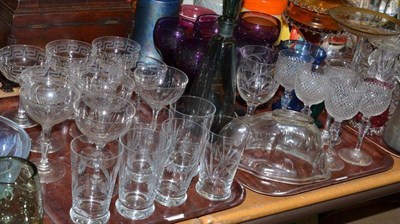 Lot 183 - Four trays of glassware containing, cranberry glass, other coloured glass, drinking glasses,...