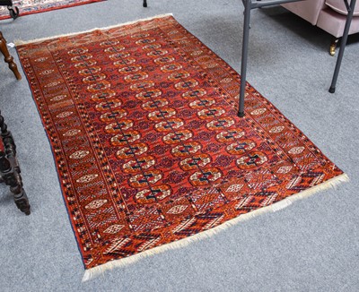 Lot 1236 - ~ A Tekke Rug, the brick red field with three...