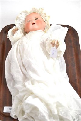 Lot 190 - An Armand Marseille bisque socket head 'Dream Baby' doll with bonnet and two gowns