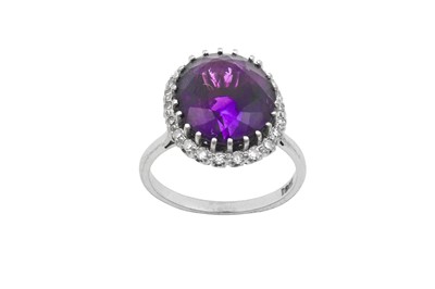 Lot 2047 - An Amethyst and Diamond Cluster Ring the oval...