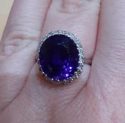 Lot 2047 - An Amethyst and Diamond Cluster Ring the oval...
