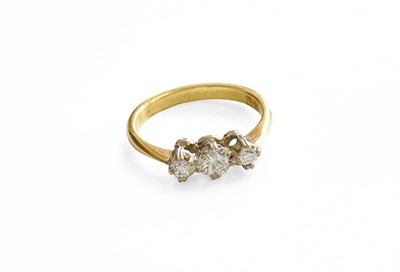 Lot 375 - A Diamond Three Stone Ring, the graduated...