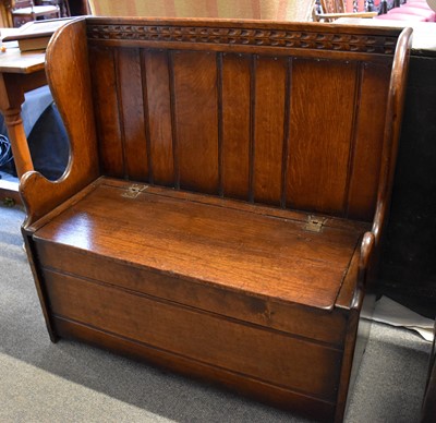 Lot 1134 - A Reproduction Carved Oak Box Settle, of small...