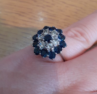 Lot 2088 - A Sapphire and Diamond Cluster Ring the round...