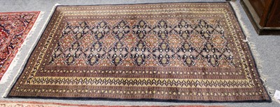 Lot 1256 - "Bokhara" Rug, the indigo field with a column...