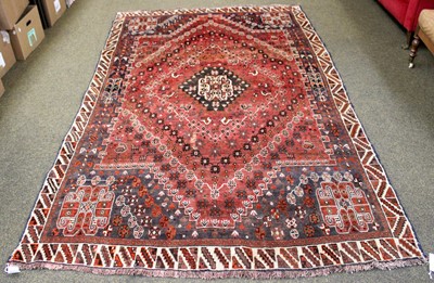 Lot 1231 - Kashgai Rug, the abrashed pale brick red field...