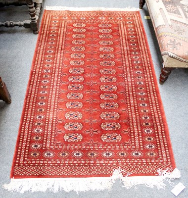 Lot 1230 - A "Bukhara" Rug, the chocolate field lattice...