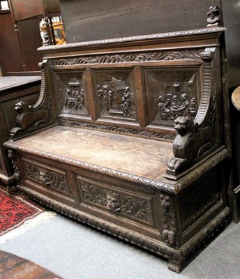 Lot 1196 - An Oak Settle, circa 1900, heavily carved with...