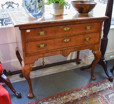 Lot 1344 - A Queen Anne Walnut Lowboy, with cross-banded...