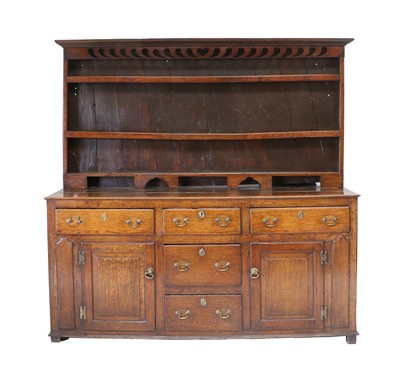 Lot 1078 - A George III Oak Enclosed Dresser and Rack,...