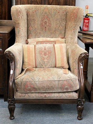 Lot 1140 - A Reproduction Upholstered Wing Back Chair, on...