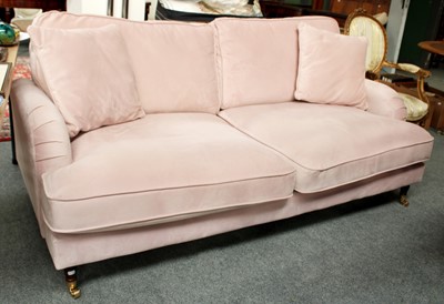 Lot 1298 - A Modern Pink Upholstered Three Seater Sofa,...