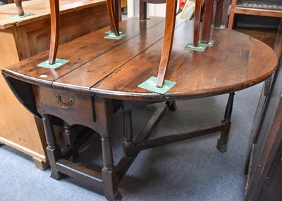 Lot 1248 - An 18th Century Gate Leg Table, on turned and...