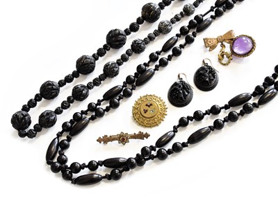 Lot 458 - A Carved Jet Bead Necklace, the graduated...