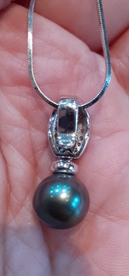 Lot 2060 - A Tahitian Cultured Pearl and Diamond Pendant...